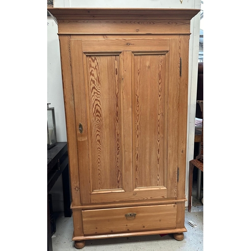 34 - A pine single door wardrobe opening to a single cross hanging rail with drawer under (H178cm W101cm ... 