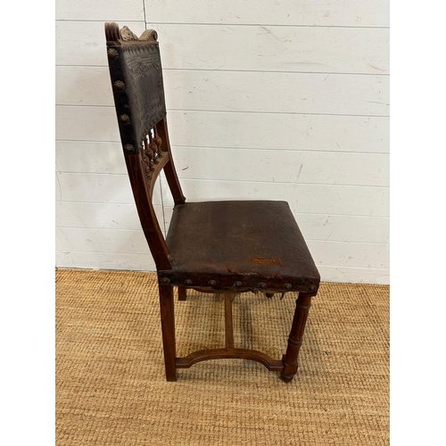 49 - A French oak and embossed leather hall chair, turned front legs and ornate floral pattern to seat ba... 