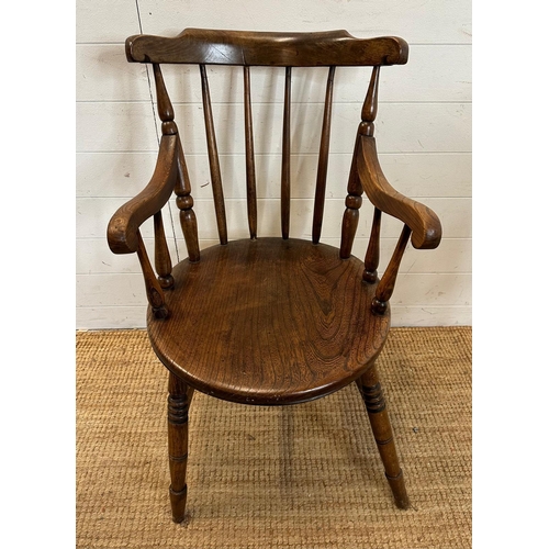 50 - A vintage oak Penny carver arm chair, spindle back and on turned legs