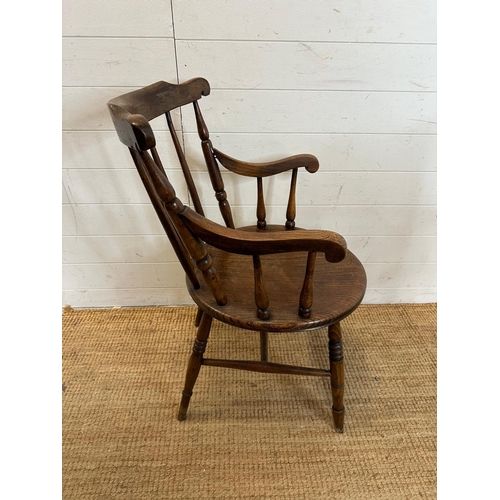 50 - A vintage oak Penny carver arm chair, spindle back and on turned legs