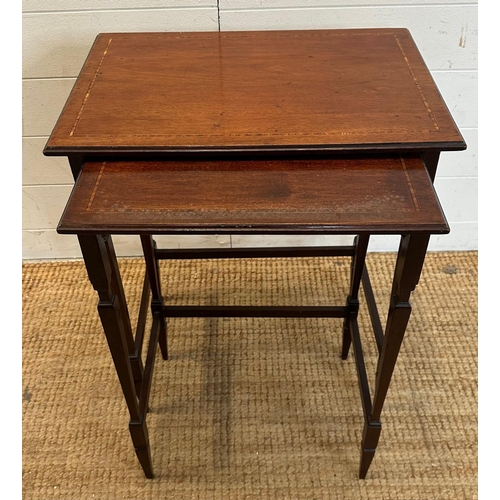 54 - A nest of two mahogany side tables with inlaid tops