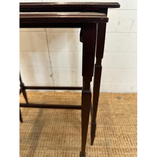 54 - A nest of two mahogany side tables with inlaid tops