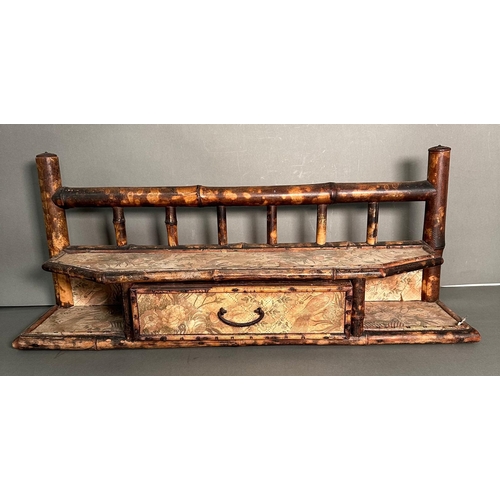 55 - A bamboo wall hanging shelf with a single drawer and floral paper lining