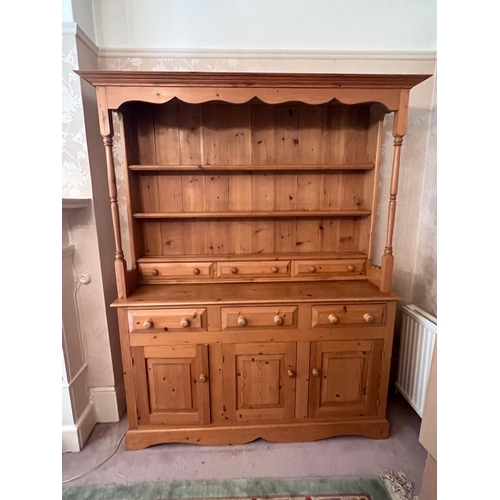 65 - A pine dresser with drawers above cupboards (H188cm W147cm D43cm)