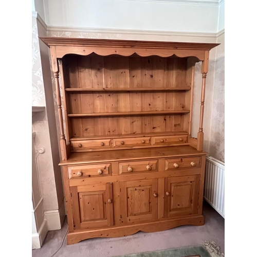 65 - A pine dresser with drawers above cupboards (H188cm W147cm D43cm)