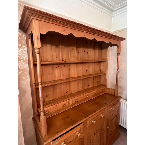 65 - A pine dresser with drawers above cupboards (H188cm W147cm D43cm)