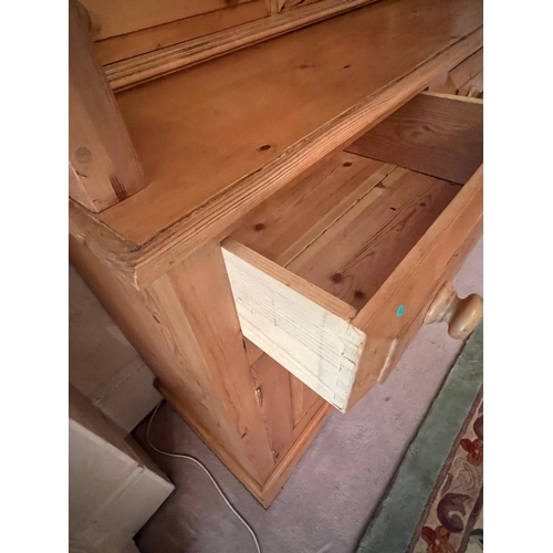 65 - A pine dresser with drawers above cupboards (H188cm W147cm D43cm)