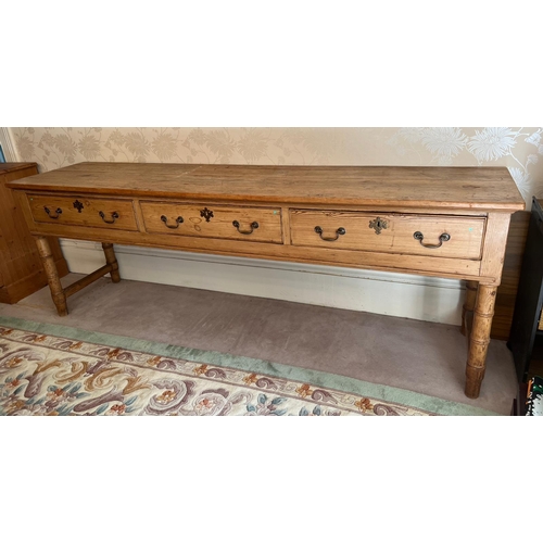 66 - A pine console table with three long drawers (H79cm W227cm D53cm)