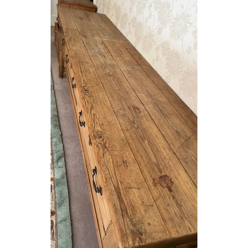 66 - A pine console table with three long drawers (H79cm W227cm D53cm)