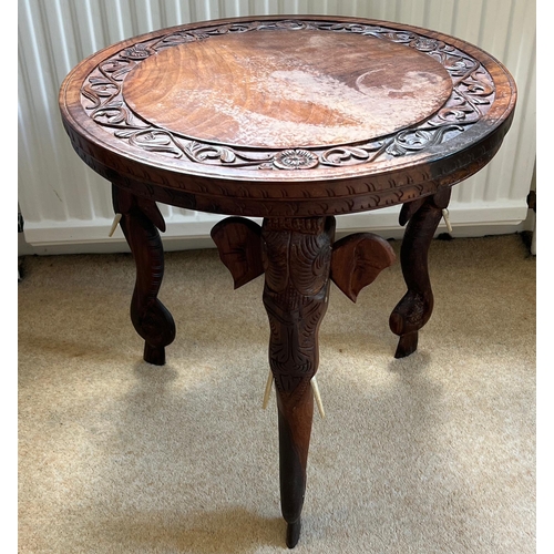 76 - An Indian hardwood side table with carved elephant legs (H46cm Dia46cm)