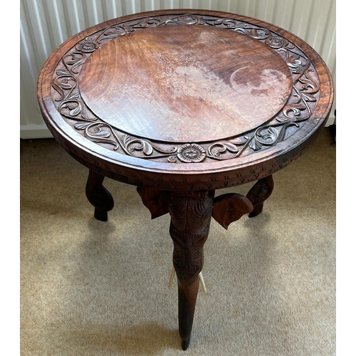 76 - An Indian hardwood side table with carved elephant legs (H46cm Dia46cm)