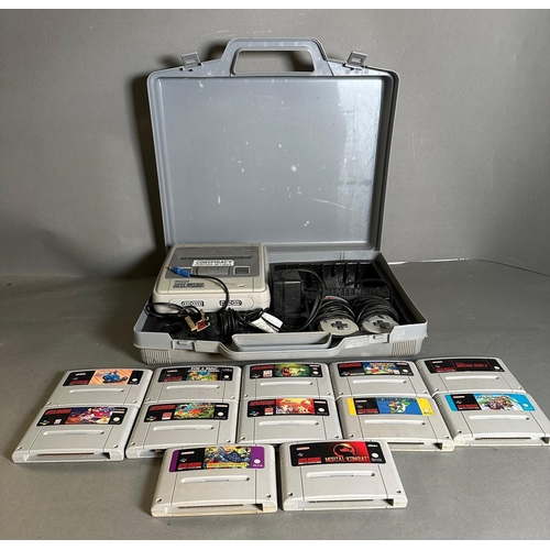 787 - A Super Nintendo games console with a collection of game cartridge to include Super Mario Kart and M... 