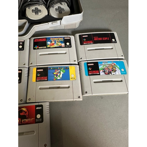 787 - A Super Nintendo games console with a collection of game cartridge to include Super Mario Kart and M... 