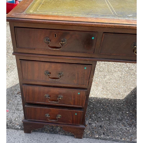 88 - A mahogany pedestal desk with green leather top