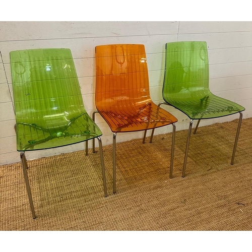 90 - Three Frovi coloured perspex chairs with chrome frames, two green and one orange