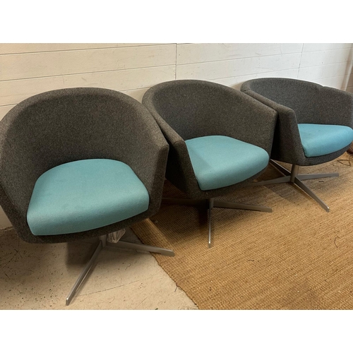 99 - Three two tone tub chairs on X frame swivel bases in grey and blue upholstery