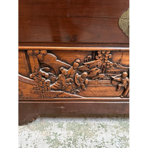 103 - A camphor wood trunk with oriental carvings to sides and tops AF (H60cm W100cm D51cm)