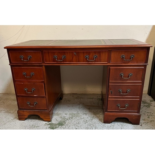 104 - A green leather topped pedestal desk, a long central drawer flanked by four short drawers and a cupb... 