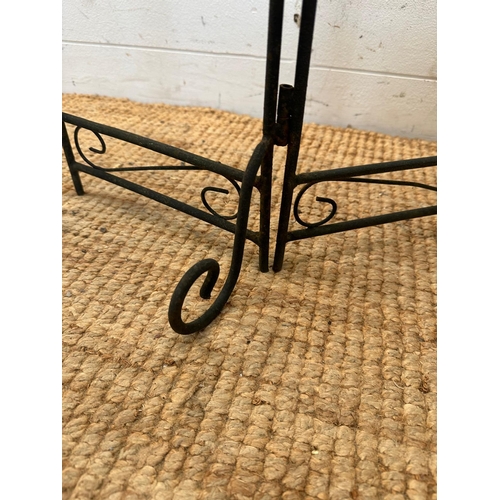 129 - A three tier wrought iron foldable plant stand