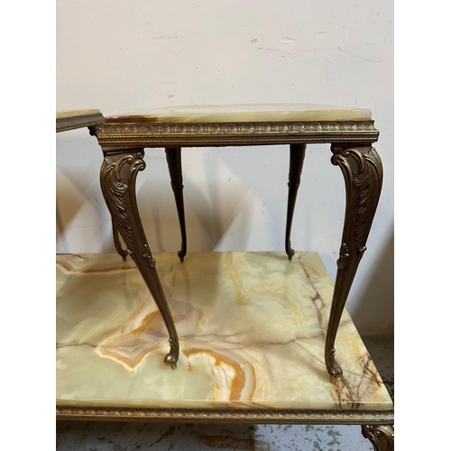 140 - A marble onyx topped coffee table on brass rococo style legs and two matching side tables (H44cm W90... 