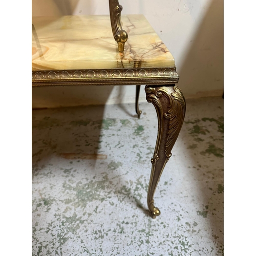 140 - A marble onyx topped coffee table on brass rococo style legs and two matching side tables (H44cm W90... 