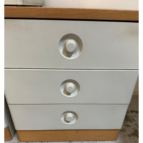 141 - A pair of grey pine topped three drawer bedside tables by Stag and a matching laundry bin (H63cm W57... 