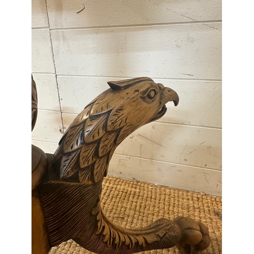 170 - A pedestal tilt top bird cage table in the Georgian style on carved tripod legs featuring eagle head... 