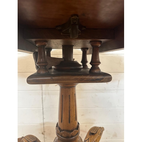 170 - A pedestal tilt top bird cage table in the Georgian style on carved tripod legs featuring eagle head... 