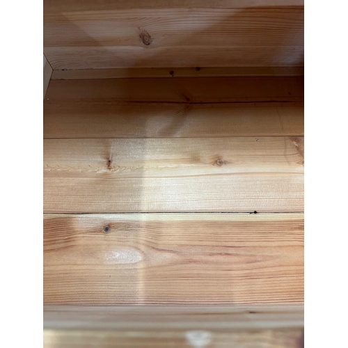 21 - A pine three drawer bedside table (H65cm W45cm D38cm)