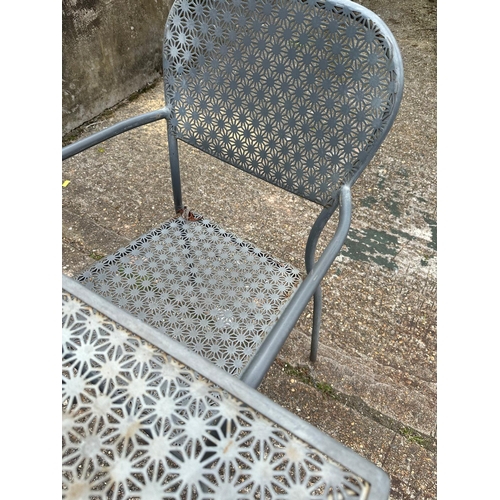 239 - A metal starburst garden table and two chairs (H73cm SQ70cm)