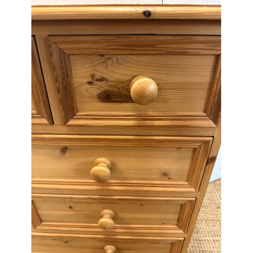 25 - A pine eight drawer chest of drawers (H87cm W101cm D44cm)