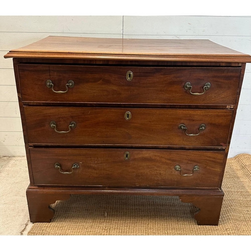 27 - A mahogany George III style chest of drawers comprising of three long drawers with brass back plate ... 