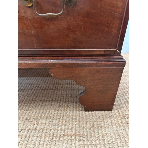 27 - A mahogany George III style chest of drawers comprising of three long drawers with brass back plate ... 