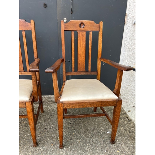 3 - A pair of oak Arts and Crafts style arm chairs with drop in seals Circa 1905