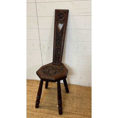 33 - An oak spinning chair with floral back and seat on turned legs