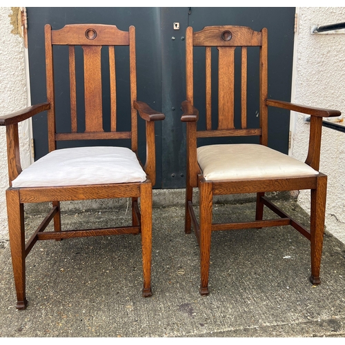 4 - A pair of oak Arts and Crafts style arm chairs with drop in seals Circa 1905