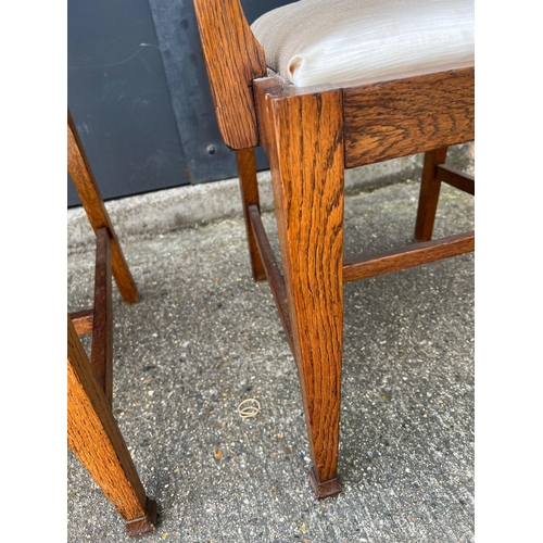 4 - A pair of oak Arts and Crafts style arm chairs with drop in seals Circa 1905