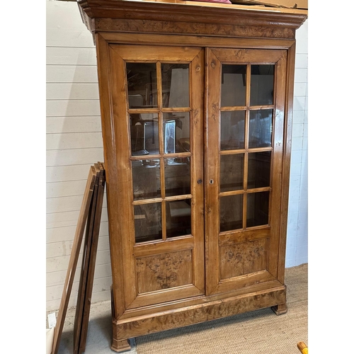 42 - A large two door cabinet comprising of two glazed doors opening to five shelves (H225cm D45cm W140cm... 