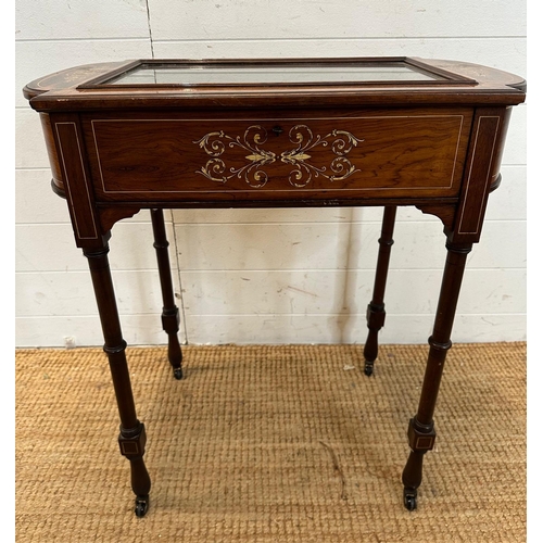 47 - A Victorian bijouterie table with string and scrolling floral inlay on turned legs and casters with ... 