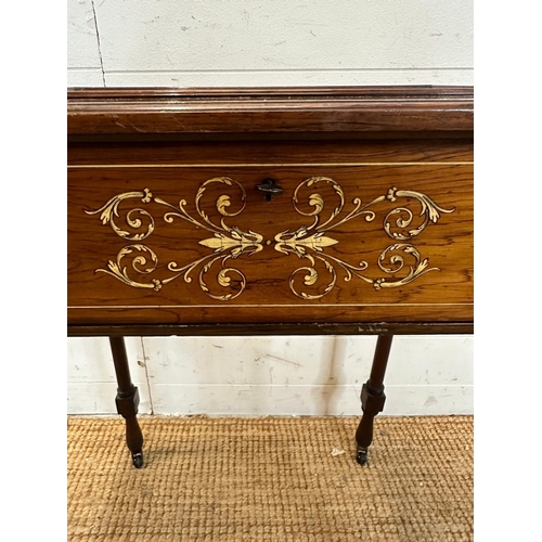 47 - A Victorian bijouterie table with string and scrolling floral inlay on turned legs and casters with ... 