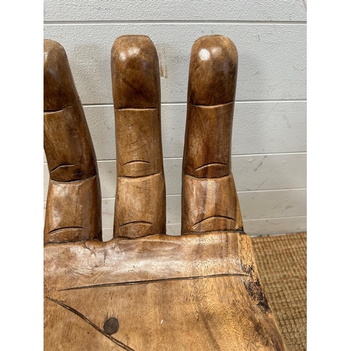 49 - A wooden carved seat or stool in the form of hand (H62cm)