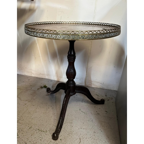 57 - A circular oak pedestal table with galleried brass top on cast iron iron splayed legs