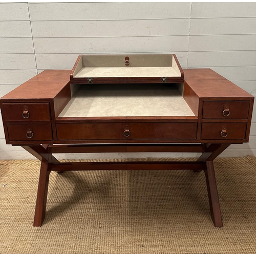 59 - A brown leather campaign style writing desk, one long central drawer flanked by two shorter drawers,... 