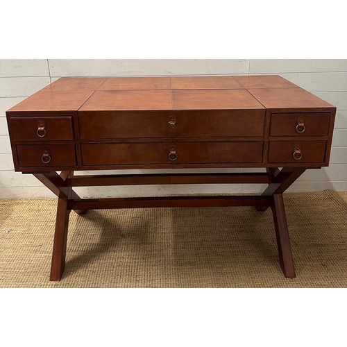 59 - A brown leather campaign style writing desk, one long central drawer flanked by two shorter drawers,... 