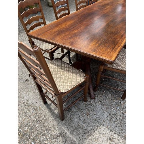 66 - A large oak dining table with ten ladder back chairs (H73cm W243cm D90cm)