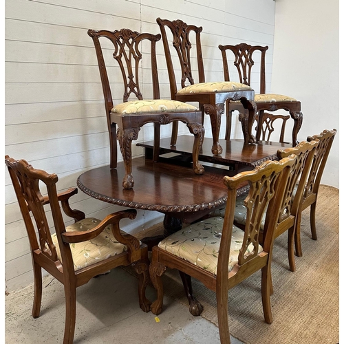 82 - An Edwardian style mahogany extending dining table on claw and ball feet and eight chairs to include... 