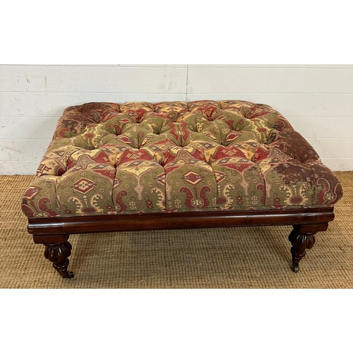 84 - A mahogany framed ottoman or foot stool button tufted and upholstered in red and greens (H46cm W100c... 