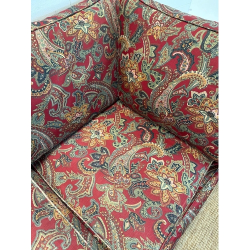 90 - A red paisley upholstered corner sofa