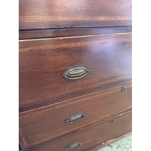 98 - A mahogany two over three chest of drawers on bun feet and brass handles (H117cm W107cm D52cm)