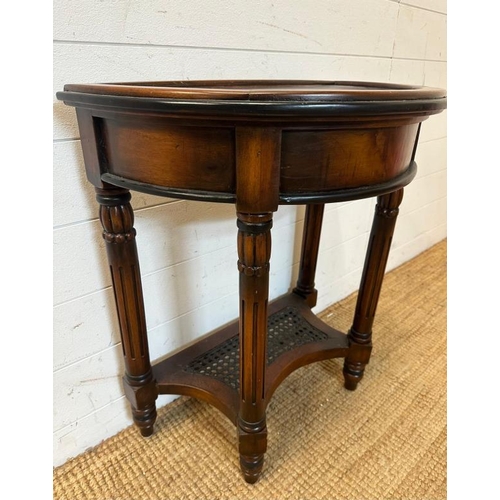 21 - A Demi Lune side table with fluted legs and cane shelf under